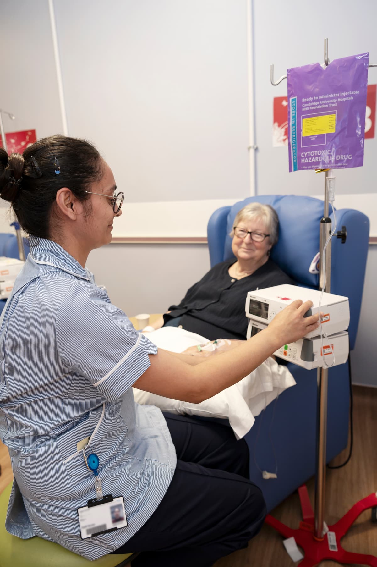 Nurse providing chemotherapy treatment to patient.