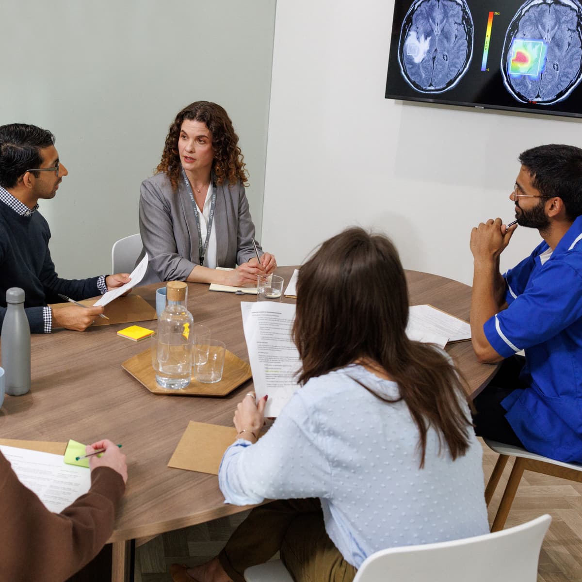 A team of doctors reviewing a patient's medical file.