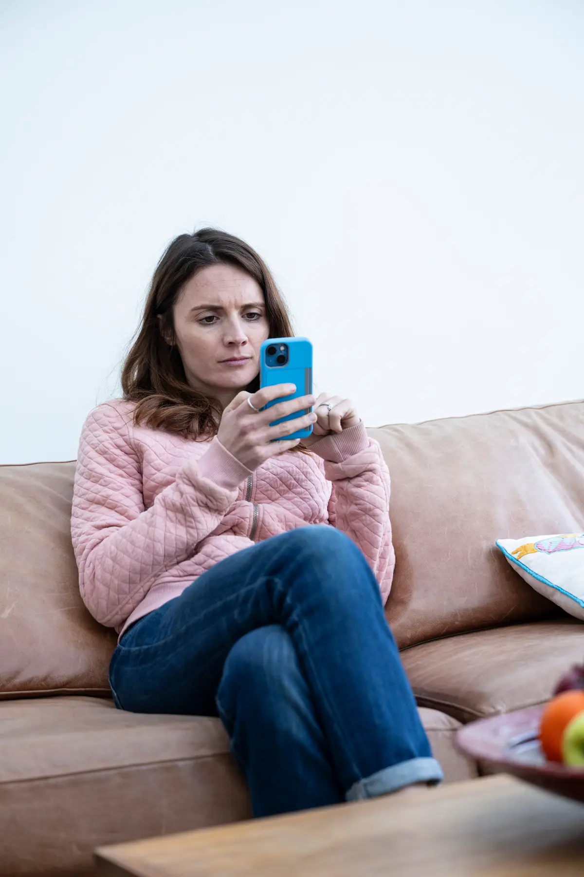 The image is of a woman typing on her phone.