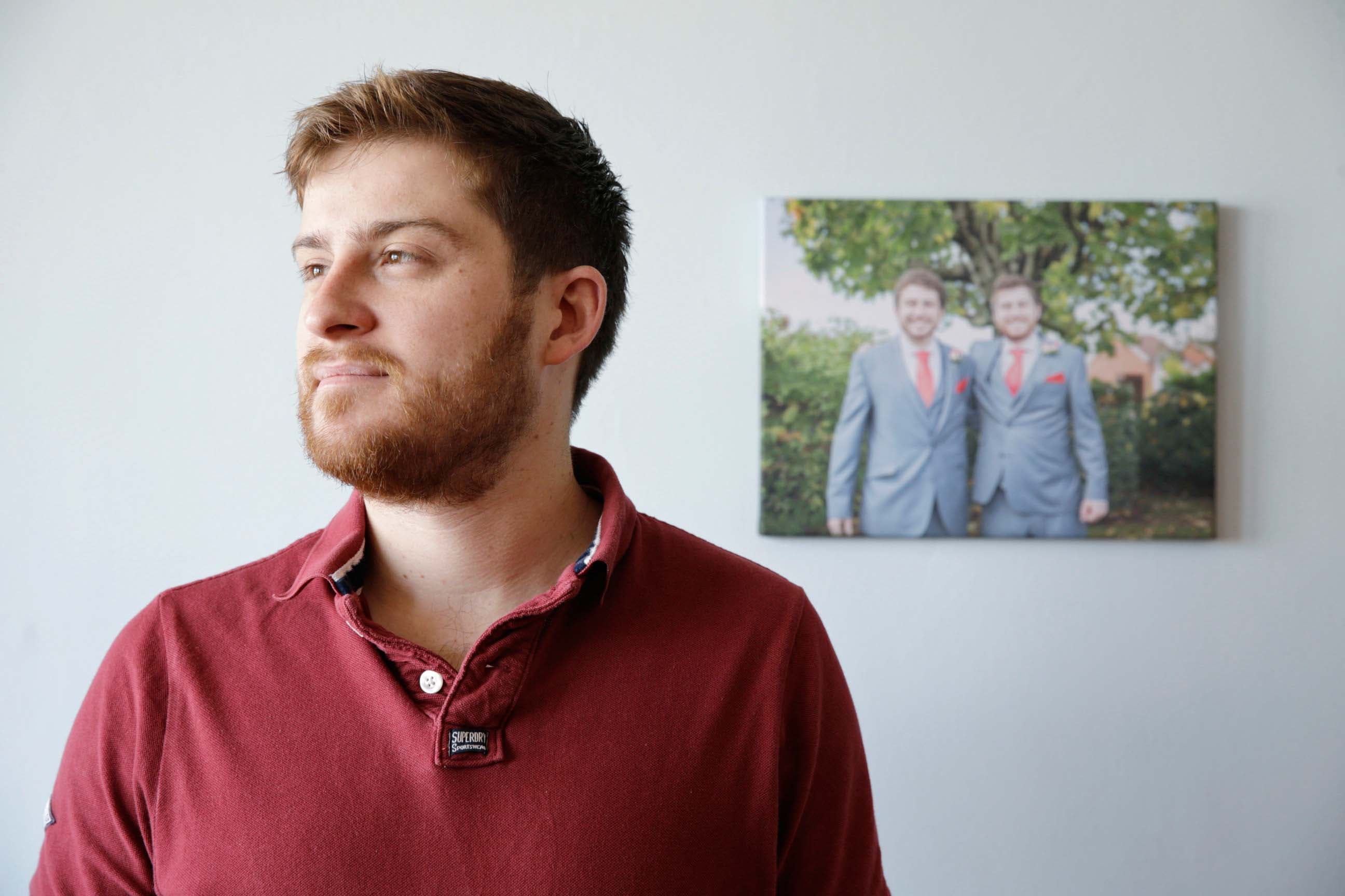 A picture of Dave with a picture of his twin brother Mark and him in the background.