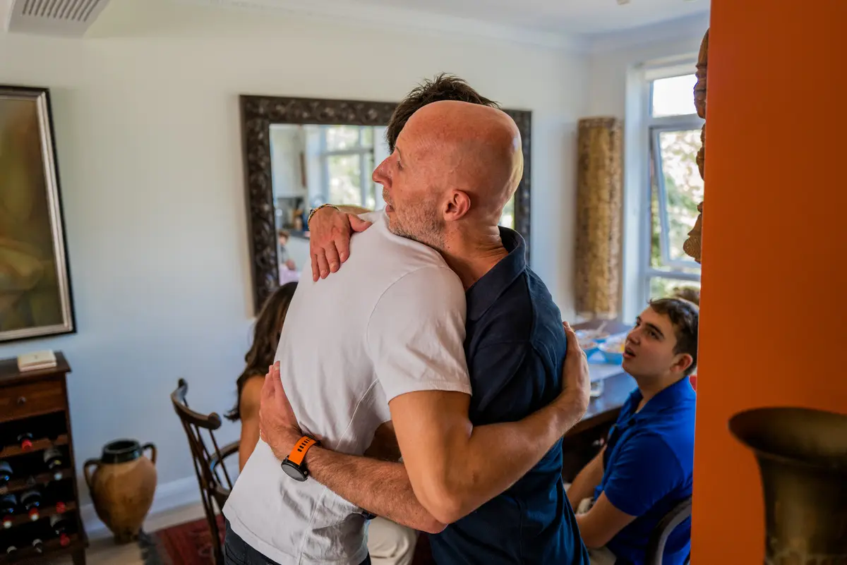 The image is of two men hugging.