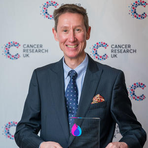 Gower holding his Flame of Hope trophy