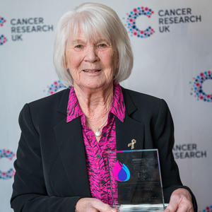 Jill holding her Flame of Hope trophy