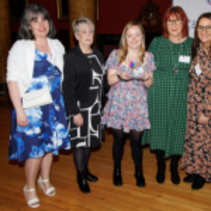 4 members of the Paisley Shop Team holding their Flame of Hope award