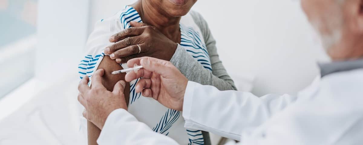 A woman getting a vaccine.